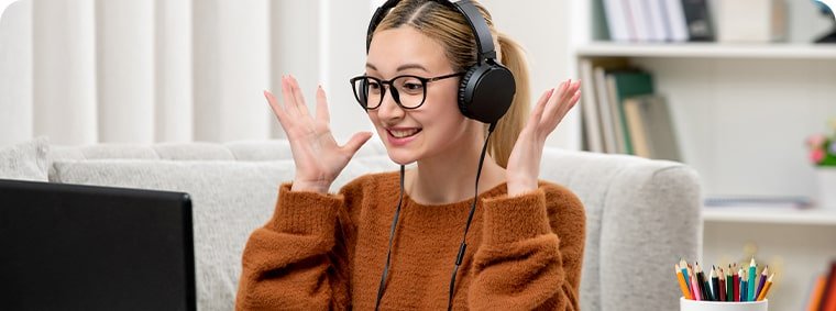 student-online-young-cute-girl-glasses-orange-sweater-studying-computer-excited-min